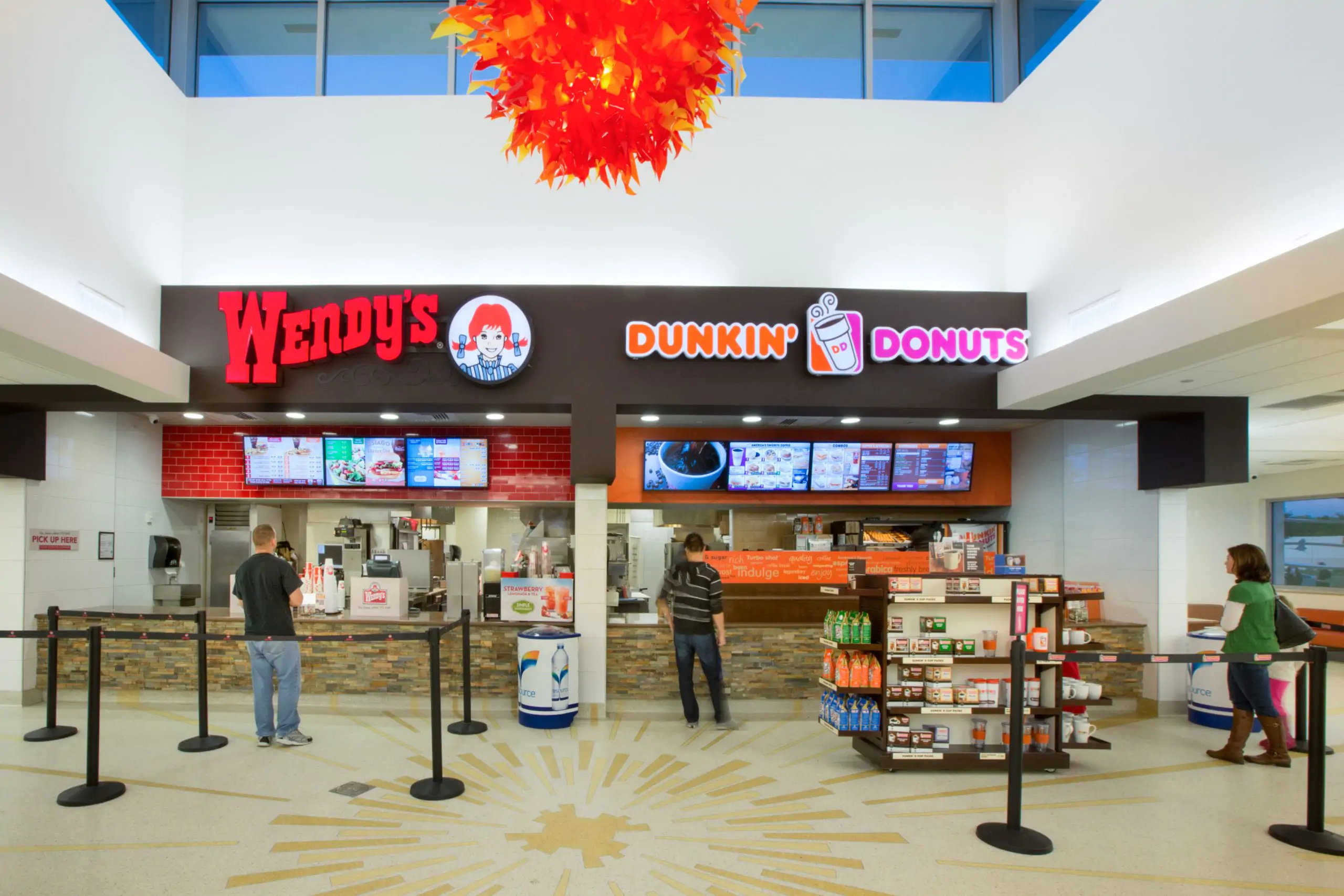 Fast food counter with Wendy’s and Dunkin’ Donuts signage.